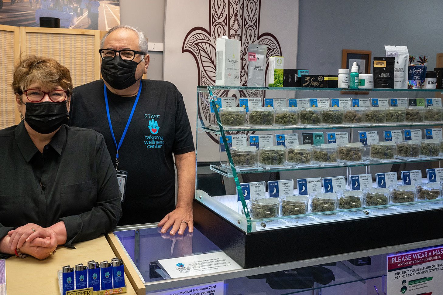 Stephanie & Rabbi Jeffery Kahn next to cannabis display inside Takoma Wellness center