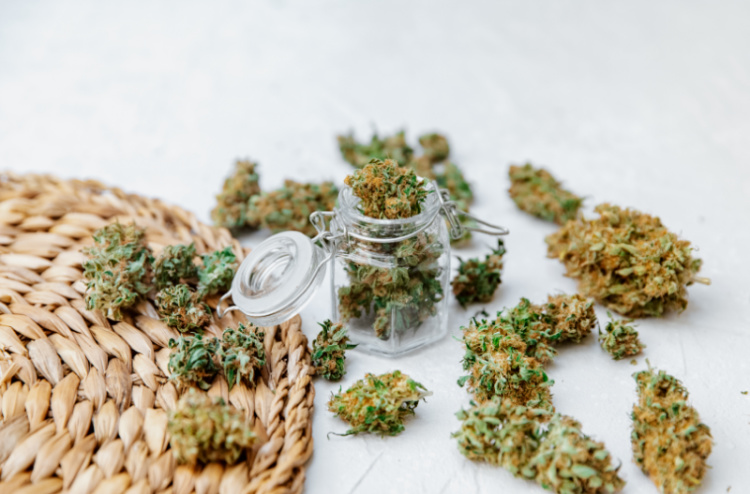Cannabis flower buds in a glass storage jar