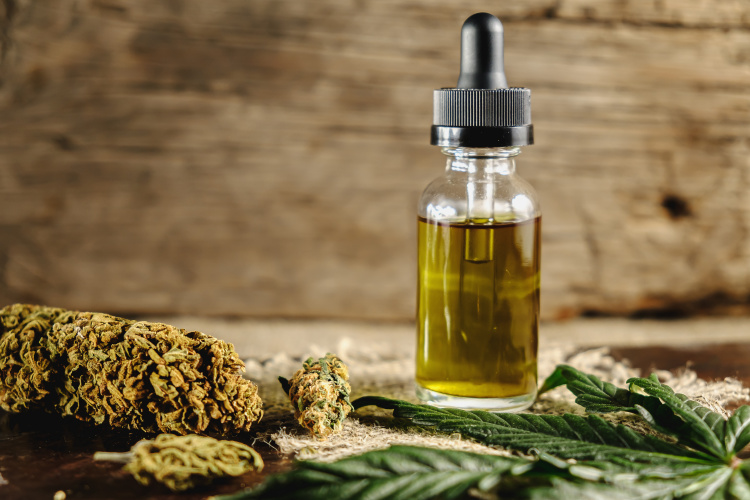 Cannabis tincture bottle with flower buds and leaves